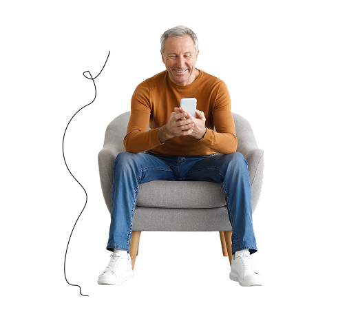 man sitting on chair looking at phone